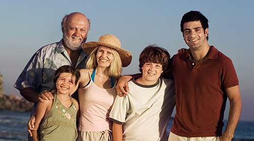 Young couple with 2 kids and grandfather at the beach - Free Insurance Quotes - Glendale, CA